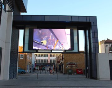 Public screen in Southend square showing a video of a bus journey upside down